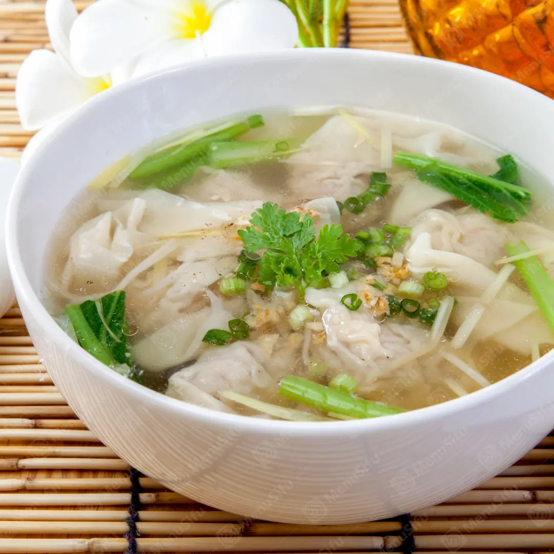 Seafood Rice Soup is a nourishing dish featuring a rice - based soup with fresh seafood like shrimp and squid, garnished with cilantro and crispy bits.